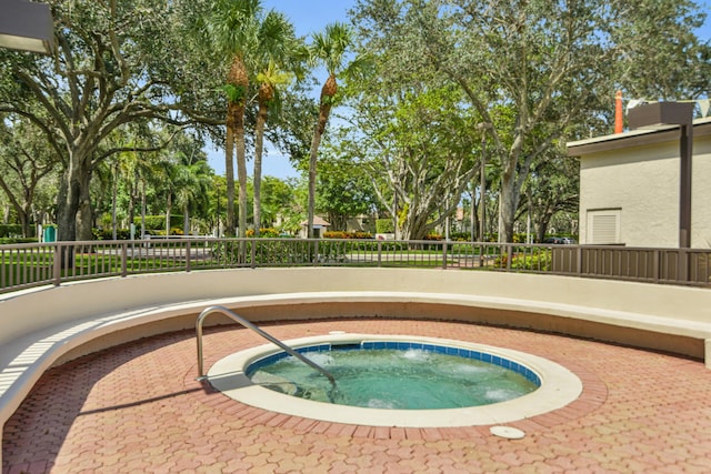 view of swimming pool featuring an in ground hot tub