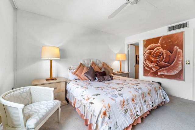 bedroom featuring carpet flooring, ceiling fan, and a textured ceiling