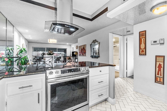 kitchen with stainless steel range with electric cooktop, dark stone counters, a textured ceiling, island range hood, and white cabinetry