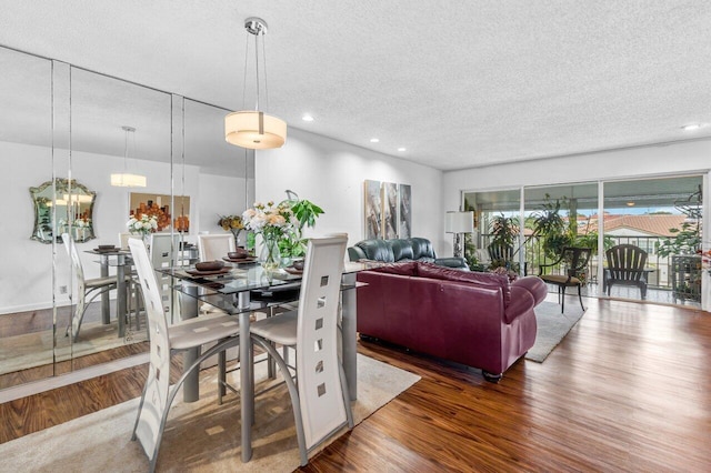 dining area with dark hardwood / wood-style floors and a textured ceiling