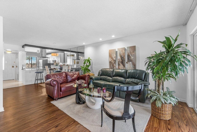 living room featuring hardwood / wood-style floors and a textured ceiling