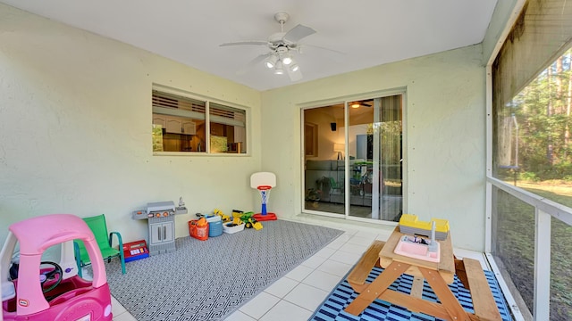 recreation room with ceiling fan and light tile patterned floors