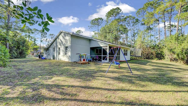 rear view of property featuring a yard