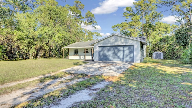 ranch-style home with a garage, a front yard, and a porch