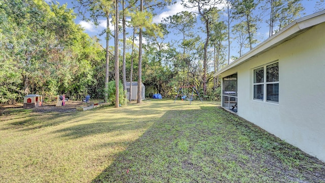 view of yard featuring a storage shed and a sunroom