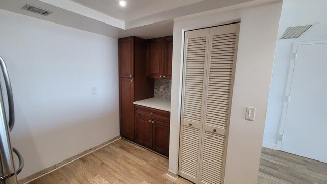 kitchen featuring light wood-type flooring and tasteful backsplash