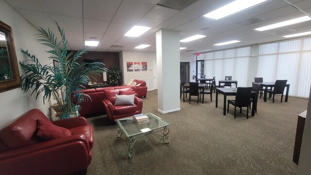 living room with a drop ceiling