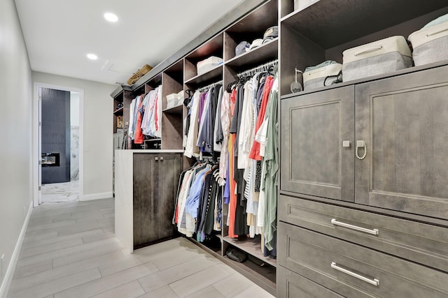 walk in closet featuring light wood finished floors