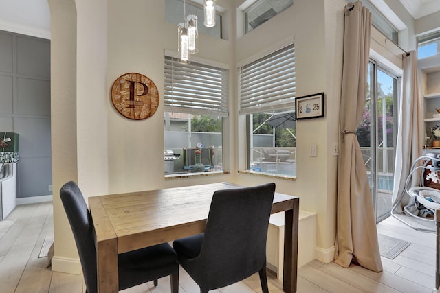 dining space with baseboards and a high ceiling