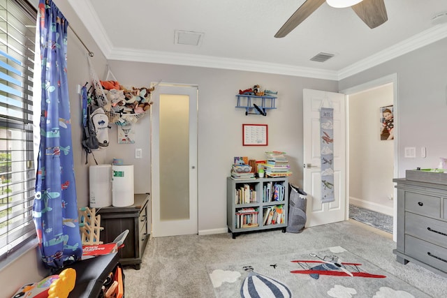 game room featuring ornamental molding, visible vents, carpet flooring, and a ceiling fan