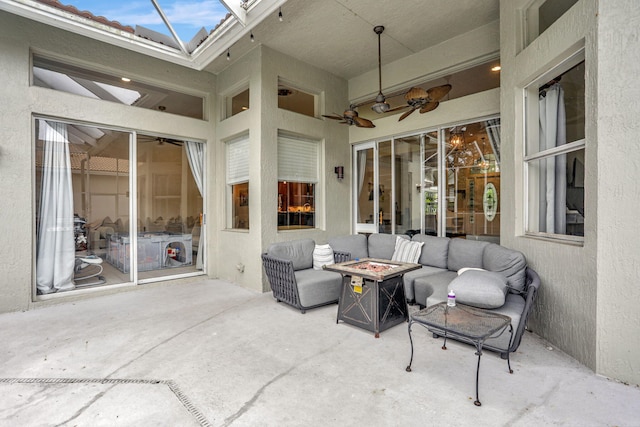 view of patio with a ceiling fan and an outdoor fire pit