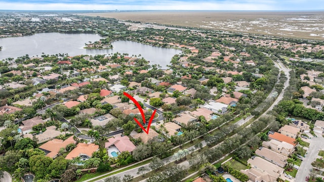 drone / aerial view with a water view and a residential view