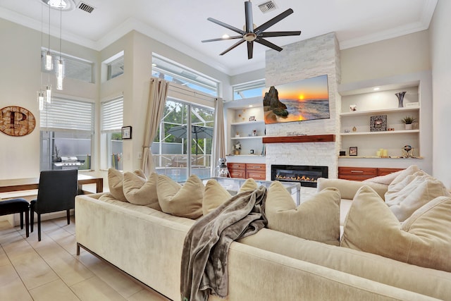 living room with visible vents, built in features, and ornamental molding