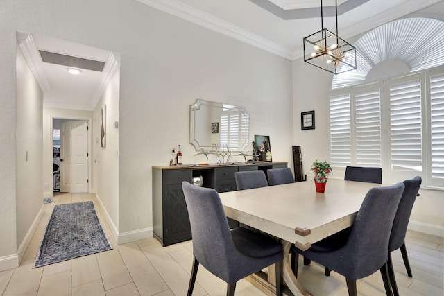 dining area with baseboards, a notable chandelier, and crown molding