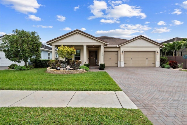 view of front of house with a front yard and a garage