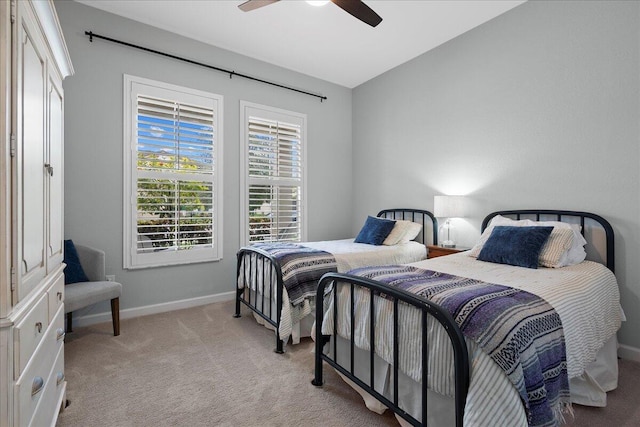 bedroom featuring ceiling fan and light carpet