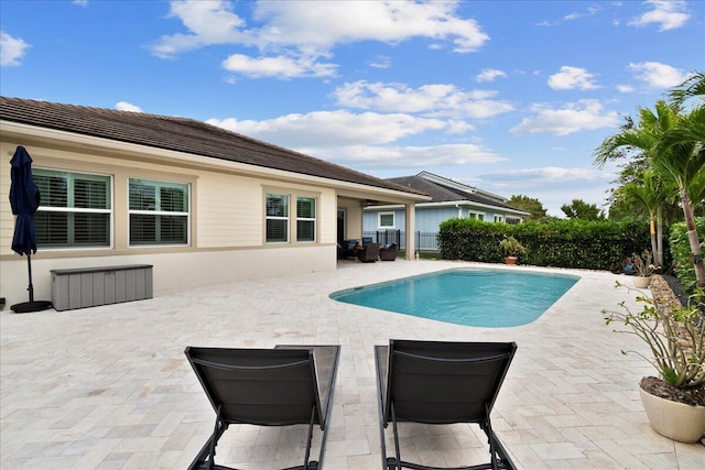 view of swimming pool featuring a patio area