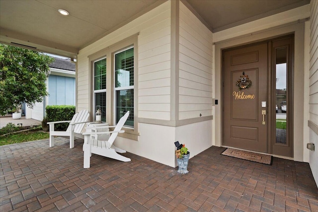 doorway to property featuring covered porch