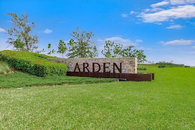 community / neighborhood sign with a lawn