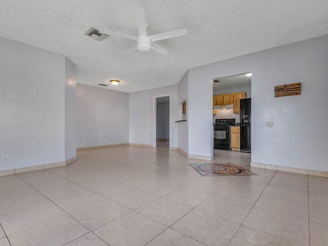 tiled empty room with a textured ceiling and ceiling fan