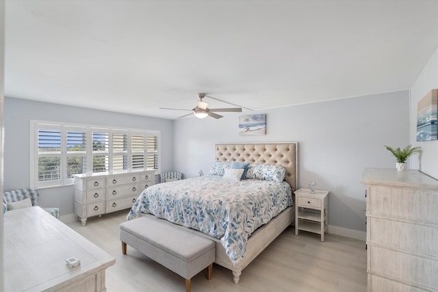 bedroom with ceiling fan and light hardwood / wood-style floors