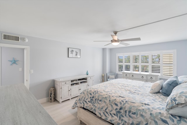 bedroom with ceiling fan and light hardwood / wood-style flooring