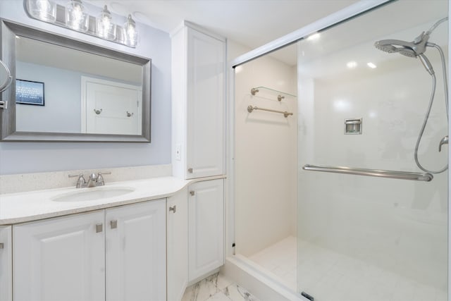 bathroom featuring vanity and a shower with shower door