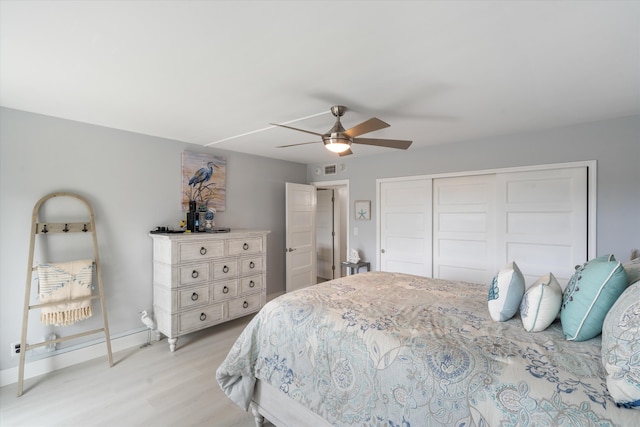 bedroom with a closet, ceiling fan, and light hardwood / wood-style floors