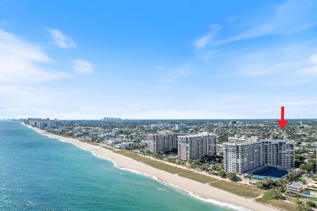 birds eye view of property with a water view and a view of the beach