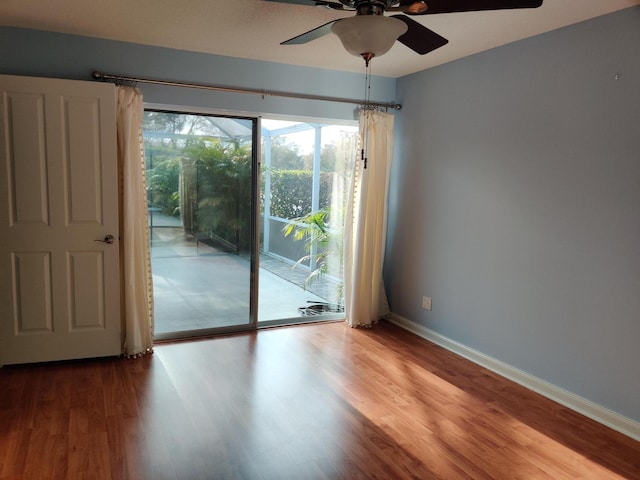 empty room with hardwood / wood-style flooring and ceiling fan