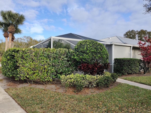 view of side of home with a lawn