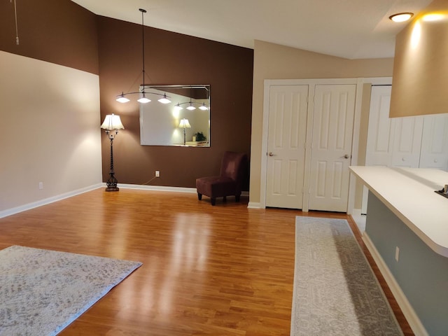 dining area with vaulted ceiling and hardwood / wood-style floors