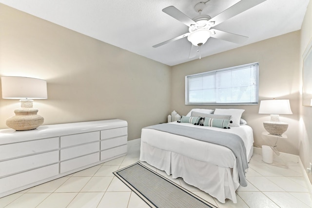 tiled bedroom featuring ceiling fan