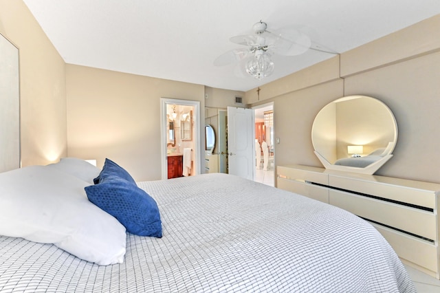 bedroom featuring ensuite bath and ceiling fan