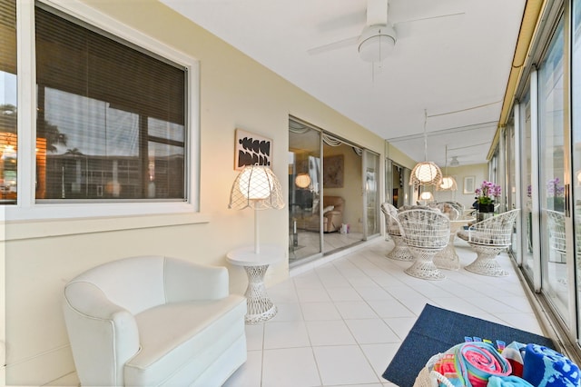 sunroom / solarium featuring ceiling fan