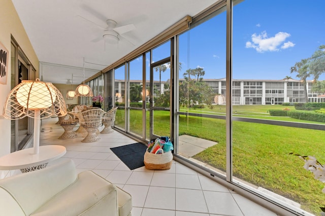 unfurnished sunroom with ceiling fan