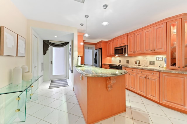 kitchen featuring light stone counters, hanging light fixtures, light tile patterned floors, and appliances with stainless steel finishes