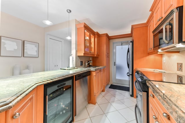 kitchen featuring sink, light tile patterned floors, appliances with stainless steel finishes, pendant lighting, and beverage cooler