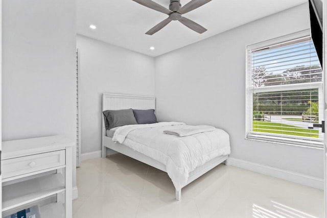 bedroom featuring multiple windows, light tile patterned floors, and ceiling fan