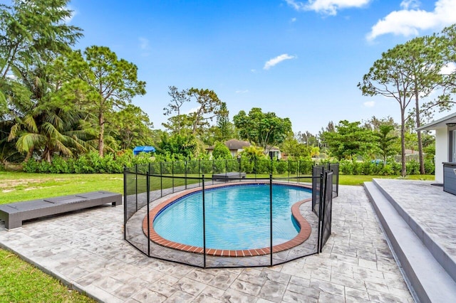 view of swimming pool with a patio area and a lawn