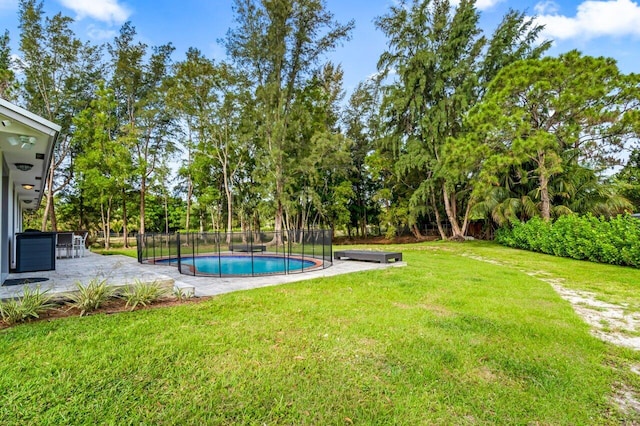 view of pool with a yard and a patio area