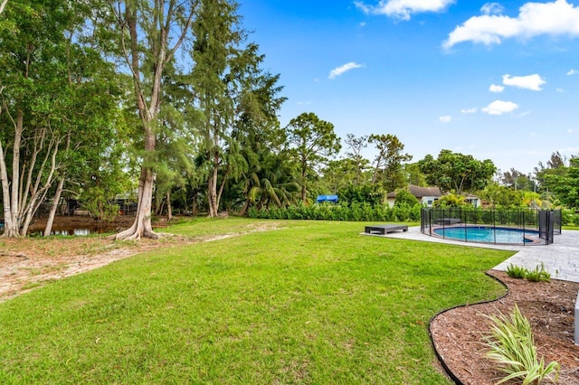 view of yard with a patio and a fenced in pool