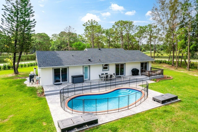 back of house featuring a patio area, a yard, and central AC