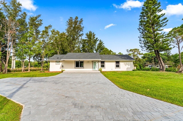 ranch-style home featuring a front yard