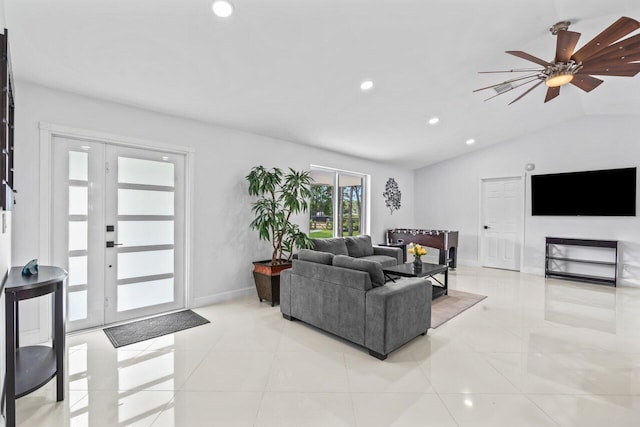 tiled living room featuring ceiling fan and vaulted ceiling