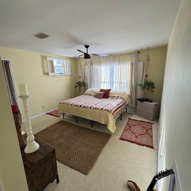 bedroom with light carpet and ceiling fan