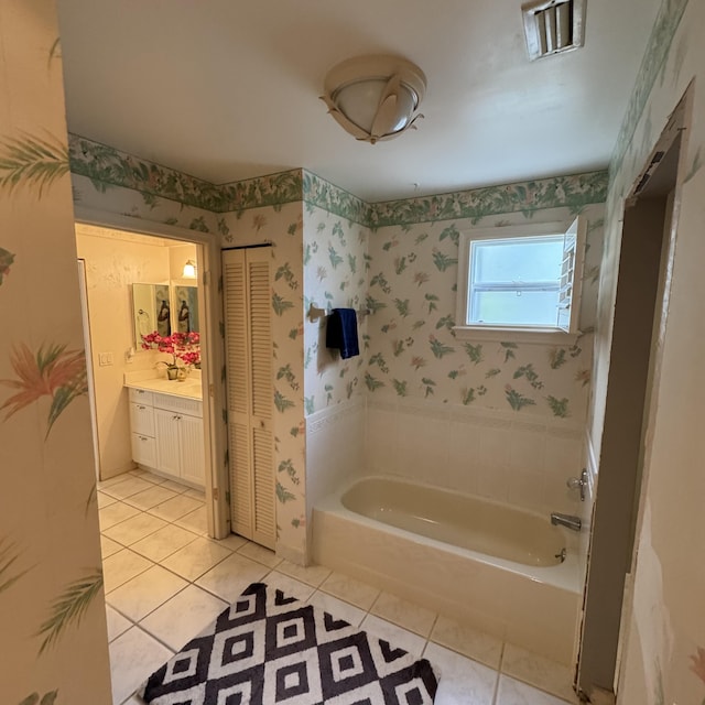 bathroom with a bathtub, tile patterned flooring, and vanity