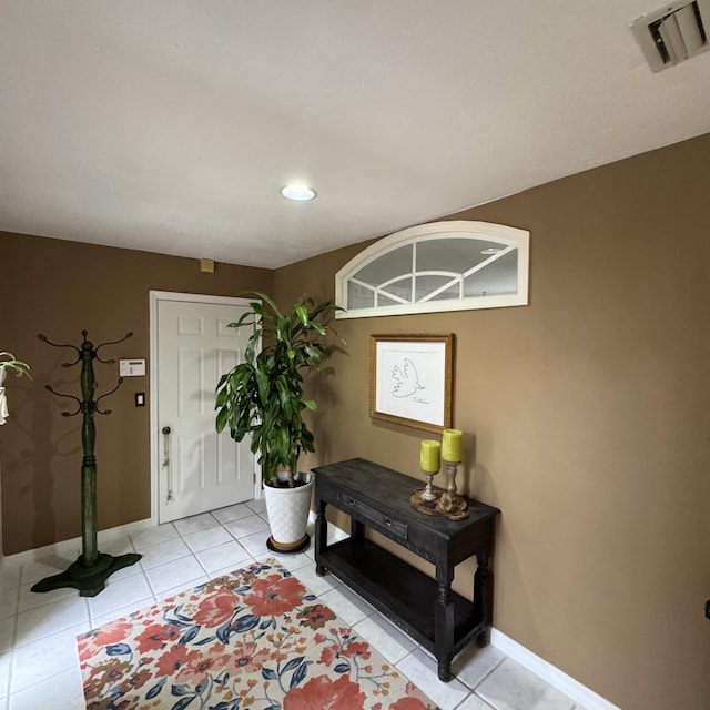 foyer entrance featuring light tile patterned flooring