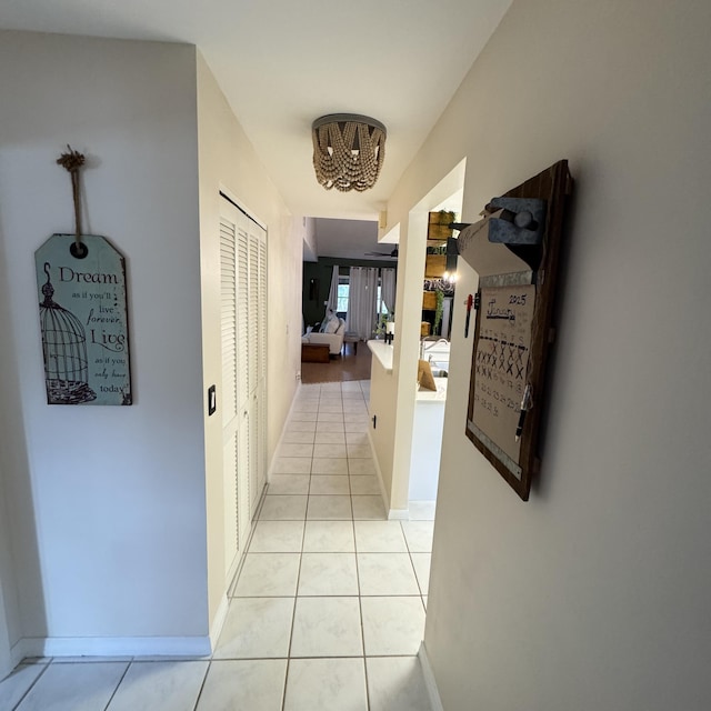 hall featuring light tile patterned floors