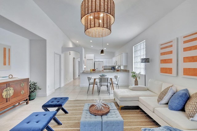 living room featuring high vaulted ceiling and light tile patterned floors